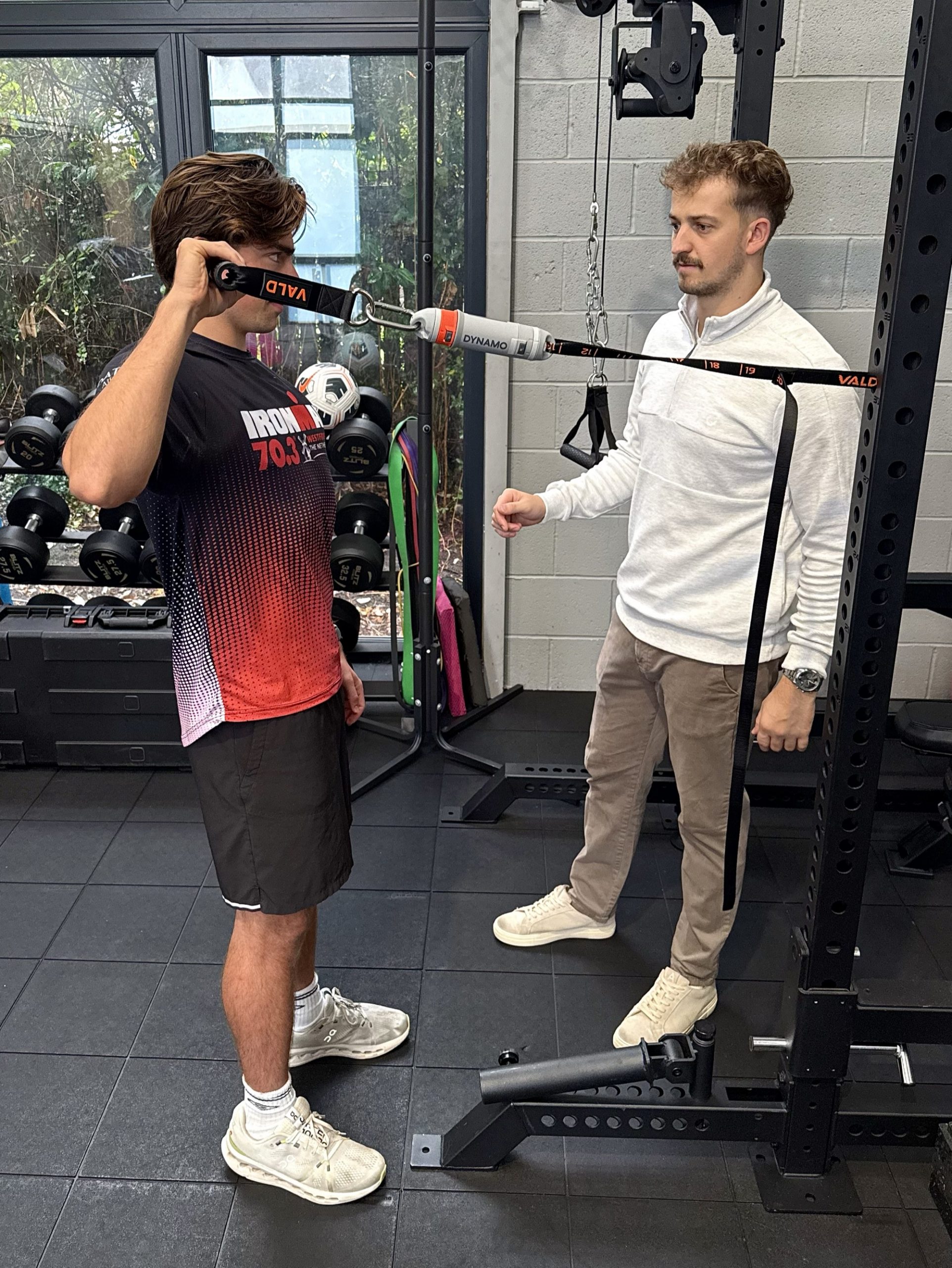 Lewis Rowe coaching a young athlete through VALD strength testing at The Physio Dorset